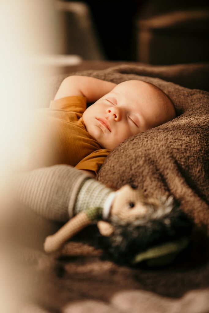 a baby lying on a blanket